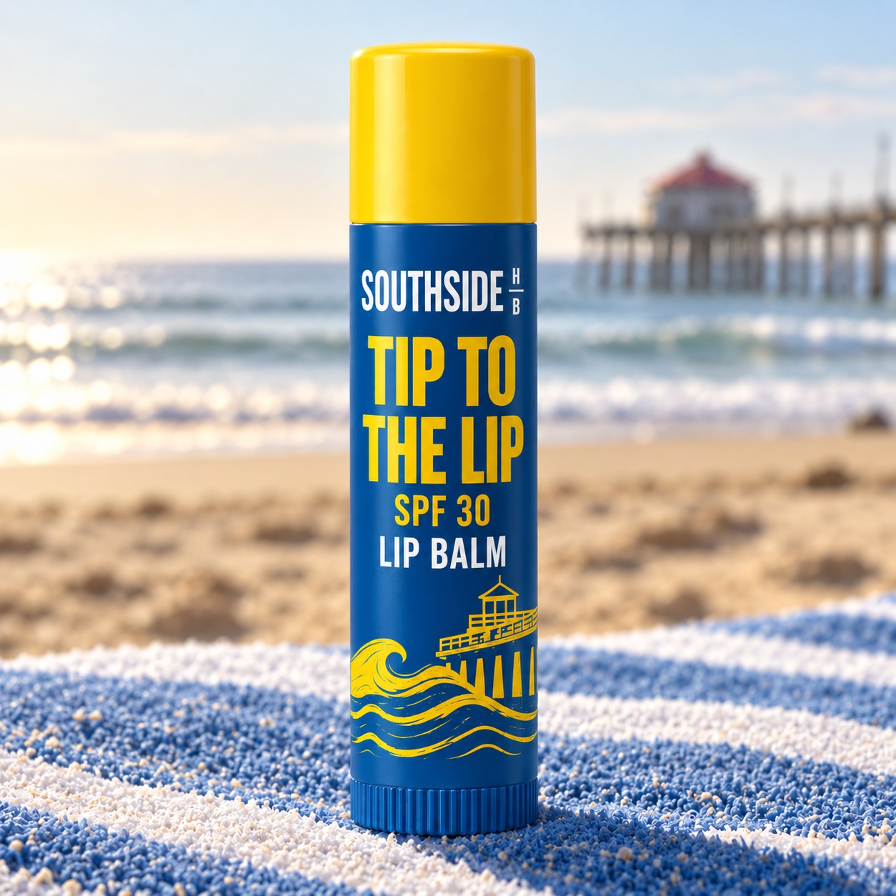 Tip to the Lip on a blue-and-white striped towel by the beach.